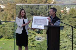 Marti Hearts, Head of School at the UC Berkeley School of Information, presents a painting of South Hall to Steve Weber.